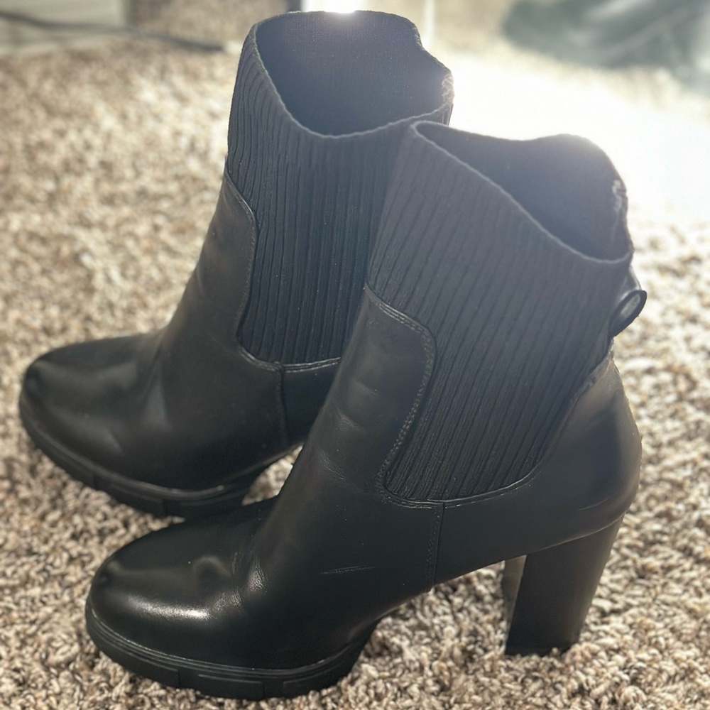 Women’s size 11 black high heeled boots.